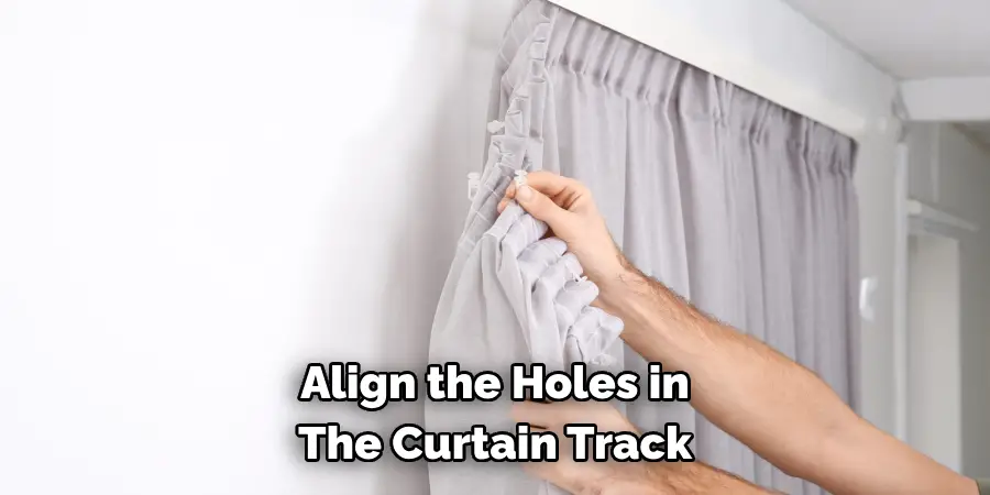 Align the Holes in 
The Curtain Track