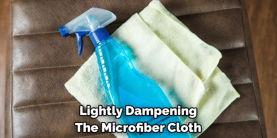 Lightly Dampening The Microfiber Cloth