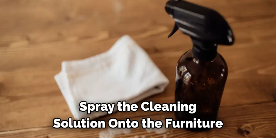 Spray the Cleaning Solution Onto the Furniture